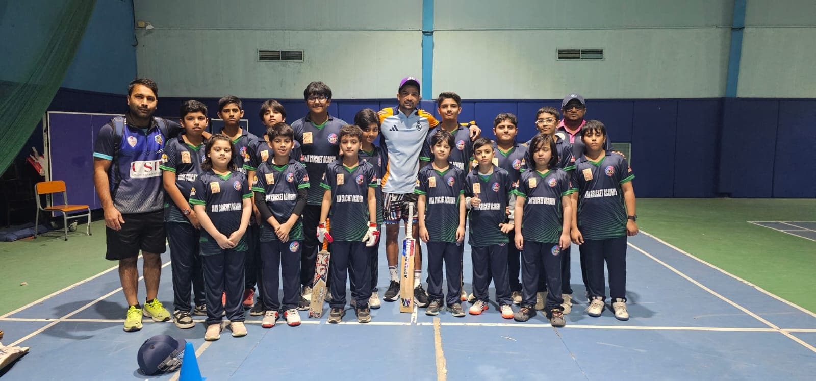 Young players training together at an indoor cricket academy session